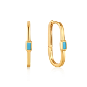 Detailed view of gold oval earrings with turquoise blue rectangular stone inlays