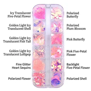Close-up of 12-grid nail art sequins box with pink shells, butterflies and heart shapes