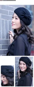 Close-up of black wool beret featuring a classic bow detail and elegant texture