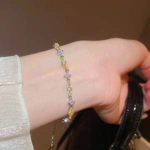 Detailed view of teardrop zircon bracelet with yellow marquise and white square gems