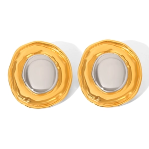 Macro detail of two-tone gold and silver circular geometric earrings with metallic texture