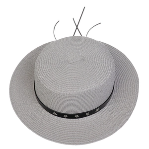 Detail of grey wide-brim straw hat with black band and silver star rivets decoration