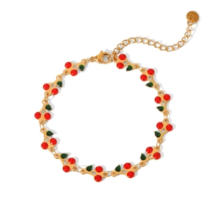 Detail of 18K gold stainless steel cherry bracelet with red and green enamel charms