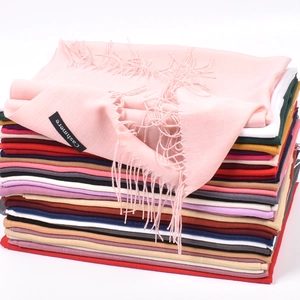 Solid color cashmere-feel scarf stack in pink, blue, yellow, and red with fringe details