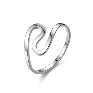 Macro shot of silver stainless steel ring with elegant polished wave-shaped fluid design