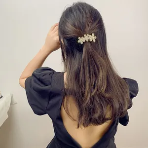 Close-up of sparkling rhinestone flower hair clip worn in a half-up hairstyle