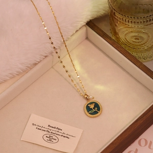 Detail of vintage gold rose pendant with deep cyan enamel and elegant white pearl