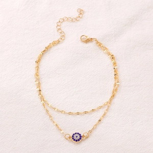 Double-layered gold evil eye anklet with blue rhinestones and adjustable link chain