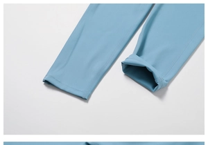 Close-up of light blue yoga leggings showing elastic fabric and reinforced seams