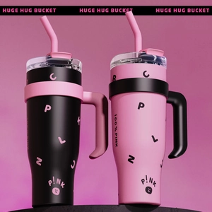 Black and pink 40oz insulated tumblers with handles and straws against a pink background