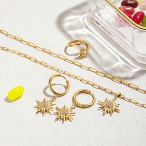 Luxury gold titanium steel sun jewelry set featuring rhinestone pendant and hoop earrings