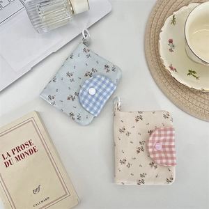 Chic floral canvas wallets with snap closures shown in a minimalist lifestyle setting