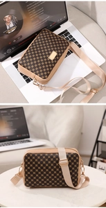 Detail view of vintage brown floral crossbody bag with wide woven strap and gold hardware