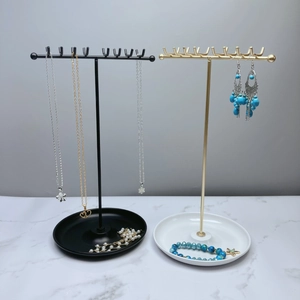Dual-row 16-hook metal T-bar jewelry display stand with round tray base for necklace storage