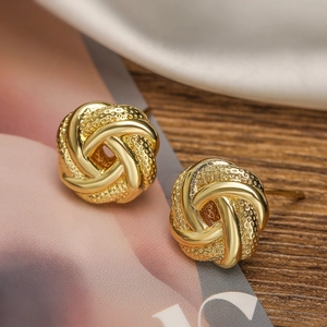 Mini gold-plated flower stud earrings featuring polished and frosted textured twist design