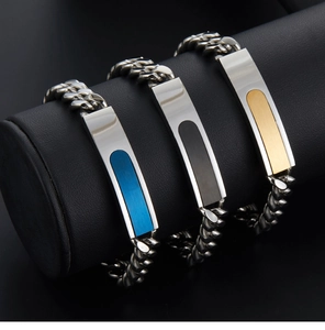 Close-up of hip-hop cuban link bracelets with blue, black, and gold inlaid metal plates