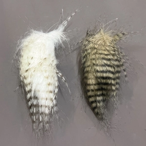 Detailed close-up of handmade striped owl feather pendants for holiday decoration