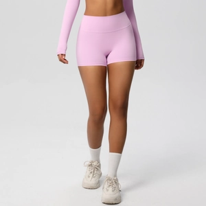 Detail of pink high-waisted yoga shorts with seamless lift and elastic fabric texture