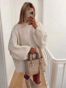 Elegant minimalist beige knit sweater with round neck and ribbed cuffs for women