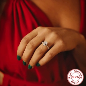 Detailed view of pear-shaped diamond ring in 925 sterling silver on a model's hand