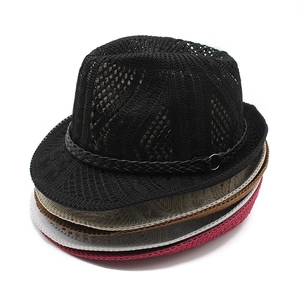 Close-up of mesh knit fedora hats stacked in multiple colors with metal buckle bands
