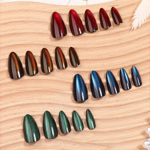 Cat eye press-on nails set in almond shape featuring four iridescent celestial colors