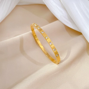 Minimalist 18K gold plated stainless steel bangle with pavé square set cubic zirconia