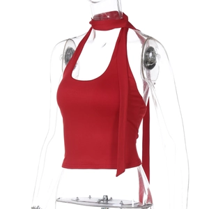 Detail of red halter neck top featuring long tie ribbons and a backless slim fit design