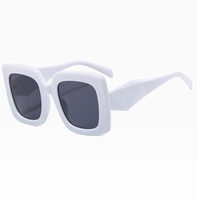 Detail view of oversized white square sunglasses with geometric temple design and dark lenses