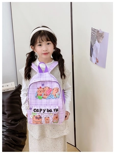 Detail of light purple checkered kids backpack with cute cartoon capybara print