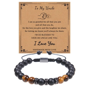 Detail of tiger eye and matte stone bead bracelet with a gift card for uncle