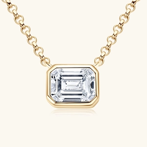 Elegant gold necklace with emerald-cut clear gemstone pendant in a minimalist bezel setting