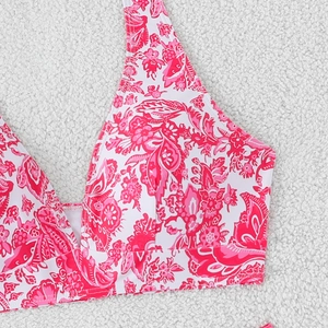 Close-up of floral bikini top with vibrant pink paisley patterns and deep V-neckline