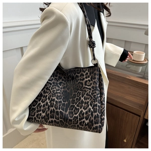 Detailed close-up of leopard print tote bag with stylish knotted shoulder strap design