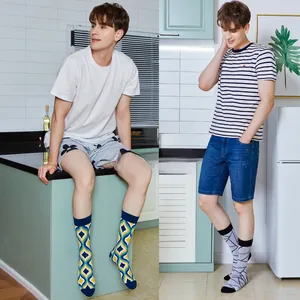 Detail of crew socks with colorful geometric jacquard patterns and ribbed elastic cuffs