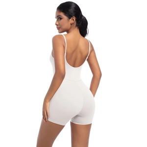 Detail of white sleeveless yoga bodysuit featuring thin straps and backless design