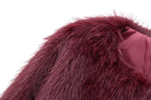 Detailed close-up of wine red faux fur texture and smooth satin lining of the jacket