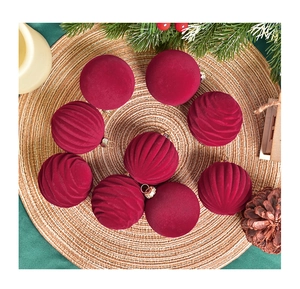 Detail of 6cm burgundy velvet Christmas balls with smooth and spiral textures on a mat