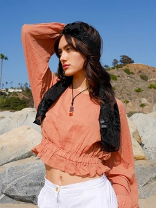 Detail showing natural Seven Chakra stone pendant necklace on a stylish female model