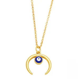 Close-up of golden crescent moon pendant featuring a blue evil eye bead on fine chain