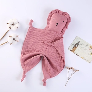 Pink muslin cotton baby security blanket with cute stuffed lion head and knotted corners