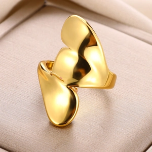 Macro shot of abstract gold butterfly ring on satin lining showing polished metal texture