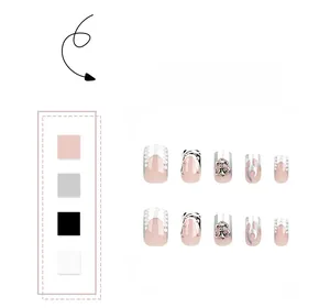Detailed close-up of nude and black flame press-on nails with metal cross charms