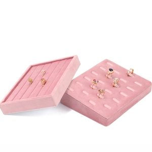 Detailed view of pink velvet jewelry tray featuring ring slots and soft texture finish