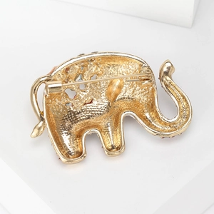 Back view of a gold elephant brooch showing a secure pin clasp on textured alloy metal