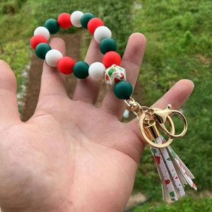 Detail of Christmas silicone bead wristlet with Santa charm and festive tassel