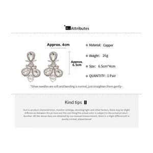 Detailed view of pear-shaped rhinestone earrings with copper base and silver pins