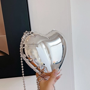 Detailed view of heart-shaped silver mirror mini bag with beaded chain strap