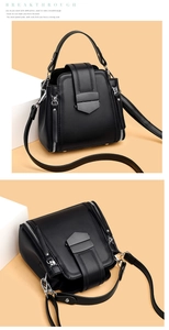 Detail view of black bucket bag featuring V-shaped stitching and metallic magnetic buckle