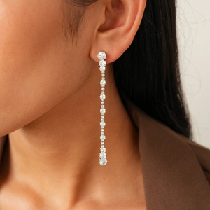 Macro shot of silver zircon tassel earrings featuring sparkling round-cut stones